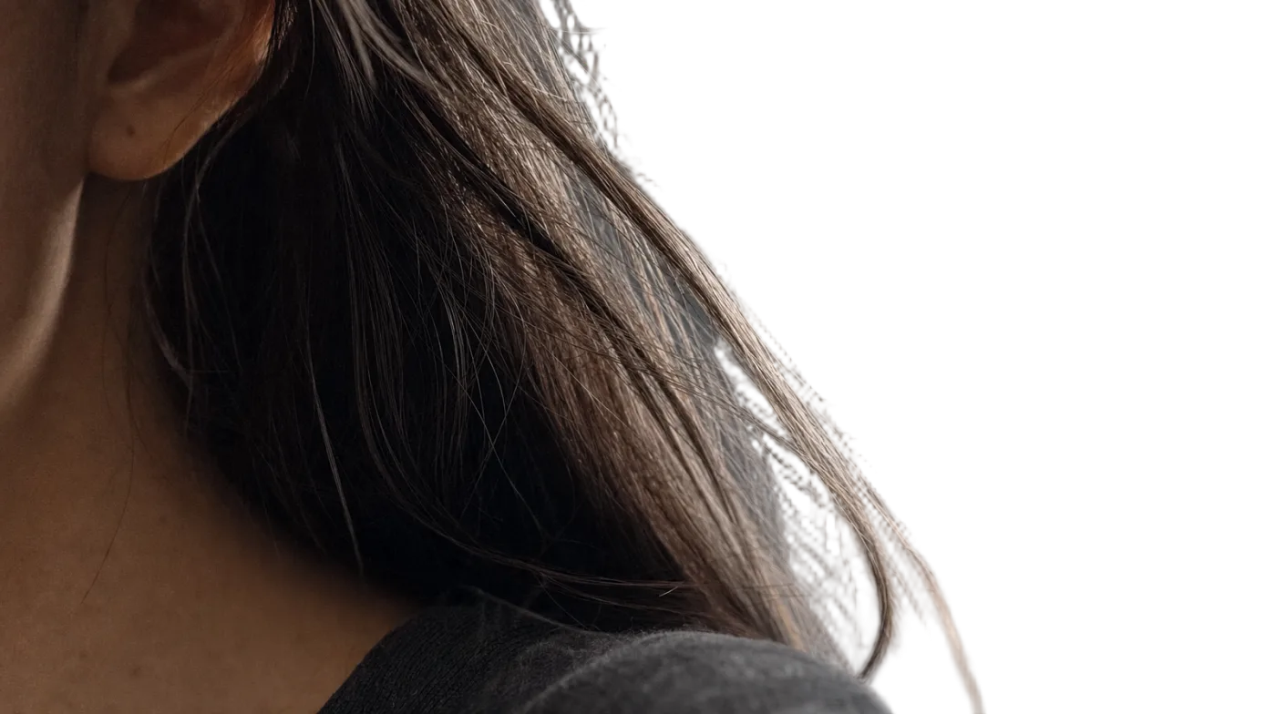 Close crop on individual hair strands preserved against a transparent background